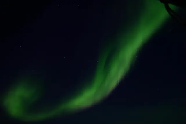 Aurora borealis in the night sky above Greenland